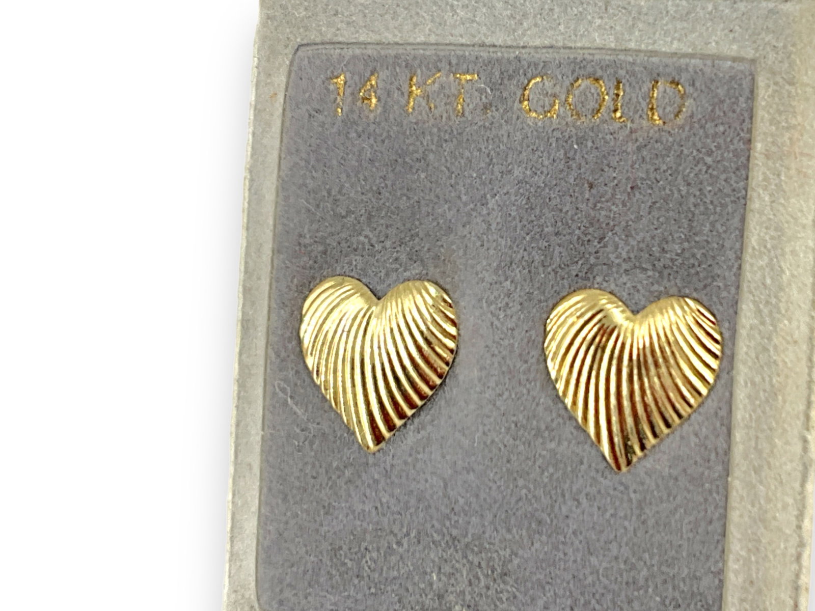 Pair of 14kt Gold Earrings: Pair of 14kt Gold Earrings Heart-shaped, stamped and tested 14kt yellow gold, pierced style on posts, 0.4 grams total weight, 10.5mm in size.