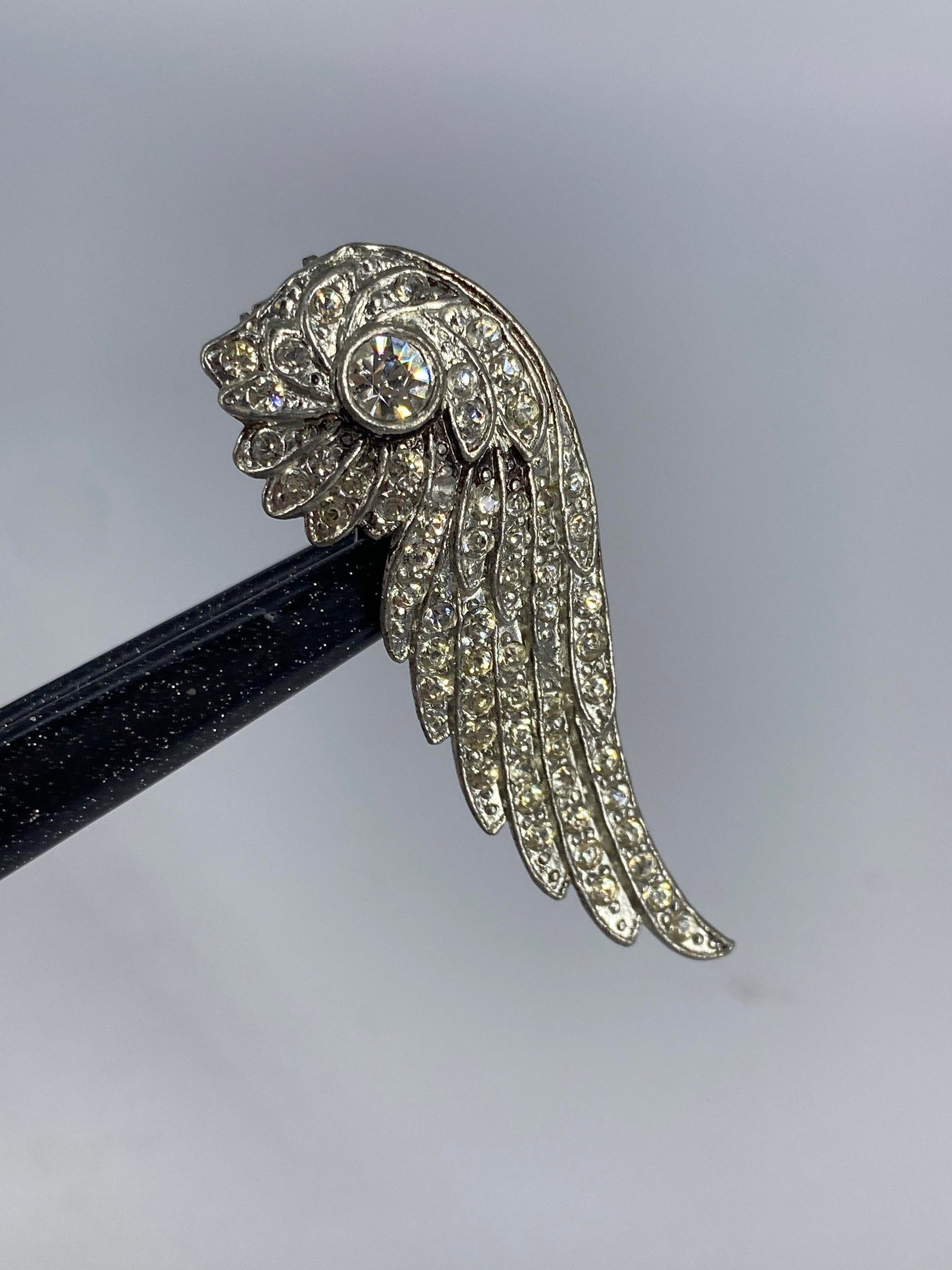 Vintage Rhinestone Dress Clip: Vintage Rhinestone Dress Clip Measuring approx. (2îx 0.74î) featuring an angel wing motif with round clear rhinestones, unknown maker.
