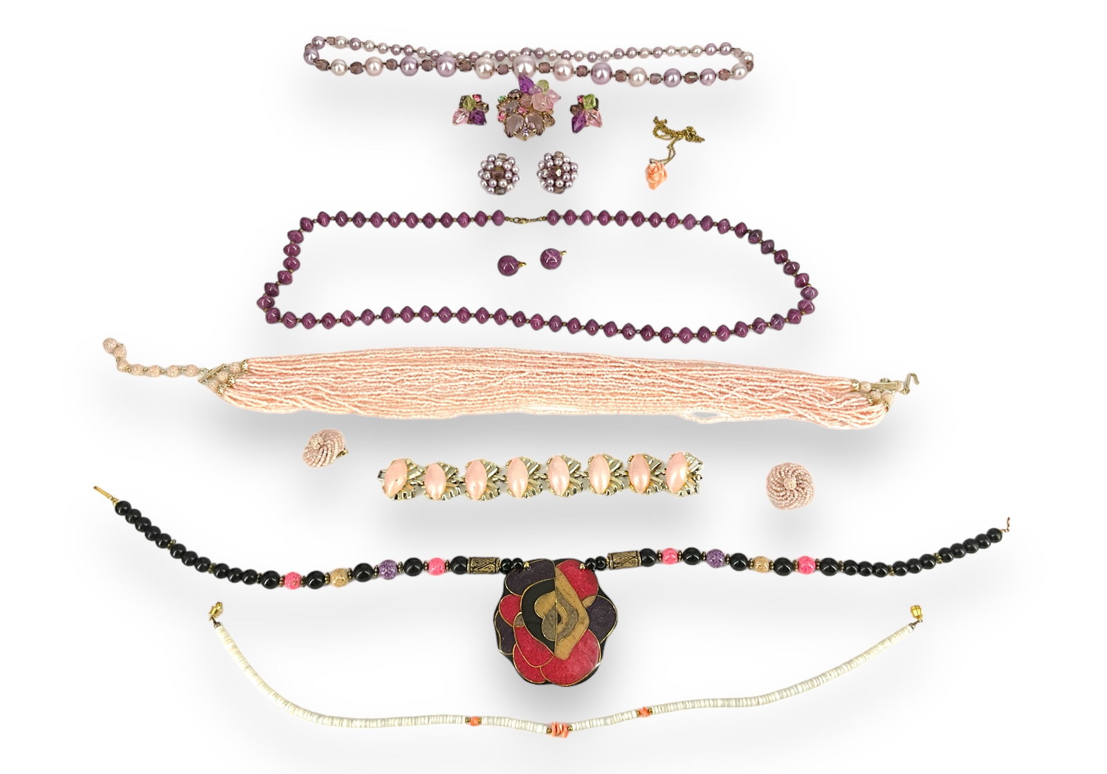 Pink Themed Fashion Jewelry Lot: Pink Themed Fashion Jewelry Lot Pretty in pink is the theme of this lot which contains a gold-tone, 7î long bracelet with 8 pink oval shaped hinged sections, a gorgeous multi-strand miniature pin