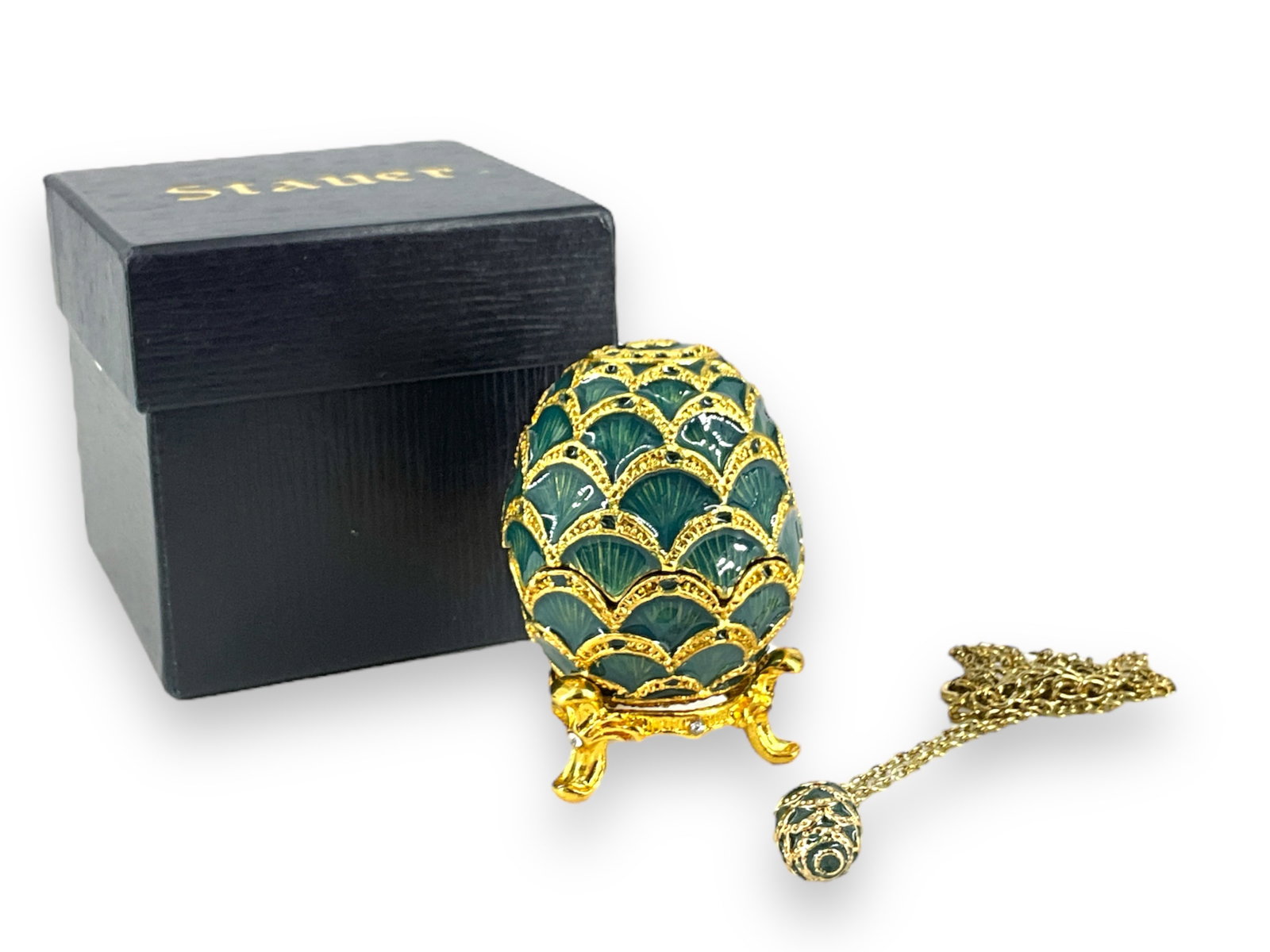 Christmas Enamel Egg Box with Necklace: Christmas Enamel Egg Box with Necklace Little green and gold-tone metal egg is approx 2 1/2î tall, has gold-tone decoration and a three-leg stand, box has a magnetic closure. Inside is a gold-ton