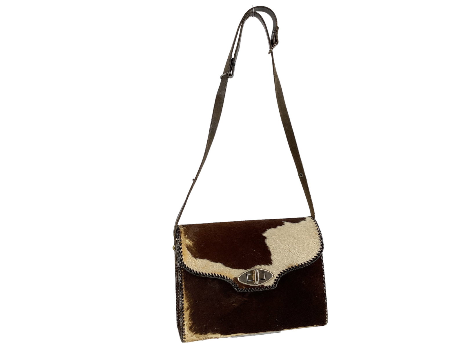 Cowhide Handbag: Cowhide Handbag Perfect for a rodeo, country concert or your cowgirl Barbie moment! Measuring approx. (11.25î x 4.6î x 8î) fold over clasp closure with a toggle, crossbody strap, unknow