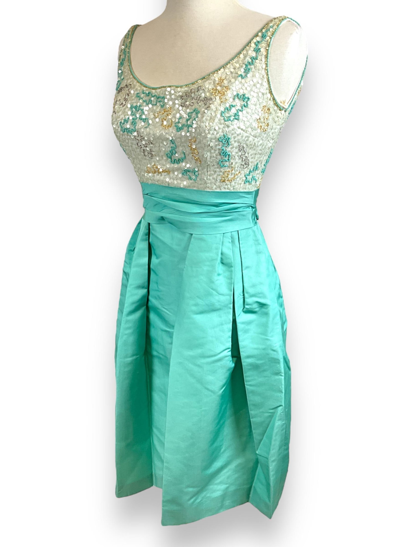 Sassy Little Green Dress: Sassy Little Green Dress Vintage light green and cream color vintage dress has a satin tag stating it was made by ìRappiî and is a size 10, dress appears to be made of a silky nylon-type mat