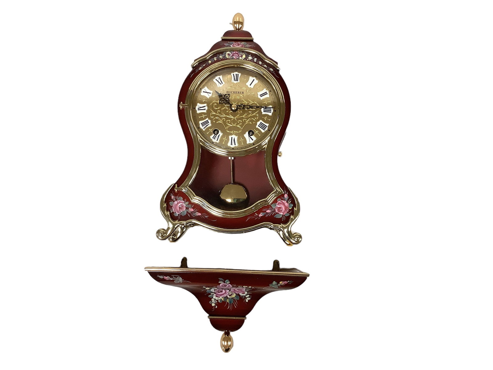 Charming Swiss-Made Bucherer Wall Clock: Beautiful hand painted violin shaped wall clock made in Switzerland by Bucherer. Complete with small pedestal shelf to hang below the clock to appear as if it is sitting on a shelf. Comes with winding