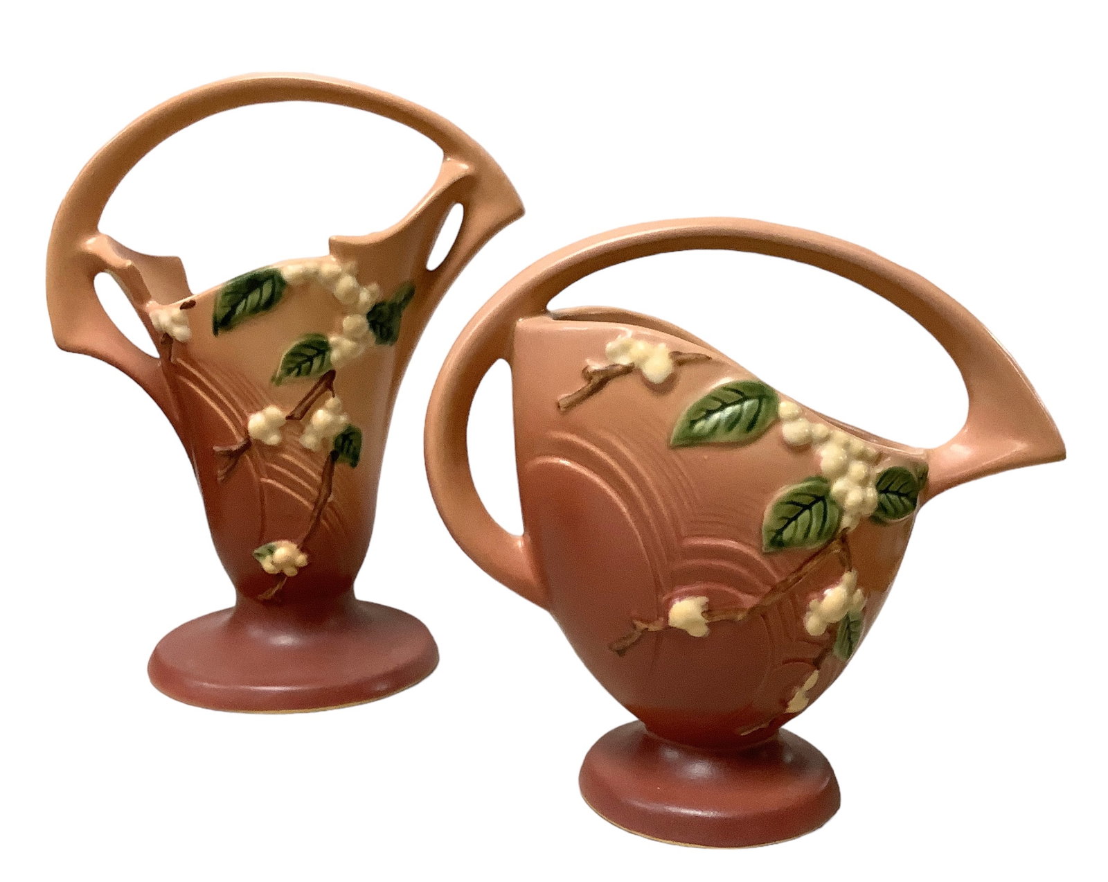 (2) Roseville Pottery: 18K-8 and 18K-10(1) 8 1/2” Roseville Pottery 18K-8 Snowberry Pink Basket Vase. (1) 10” Roseville Pottery 18K-10 Snowberry Dusty Rose Basket Handle Vase. No chips or cracks at time of listi