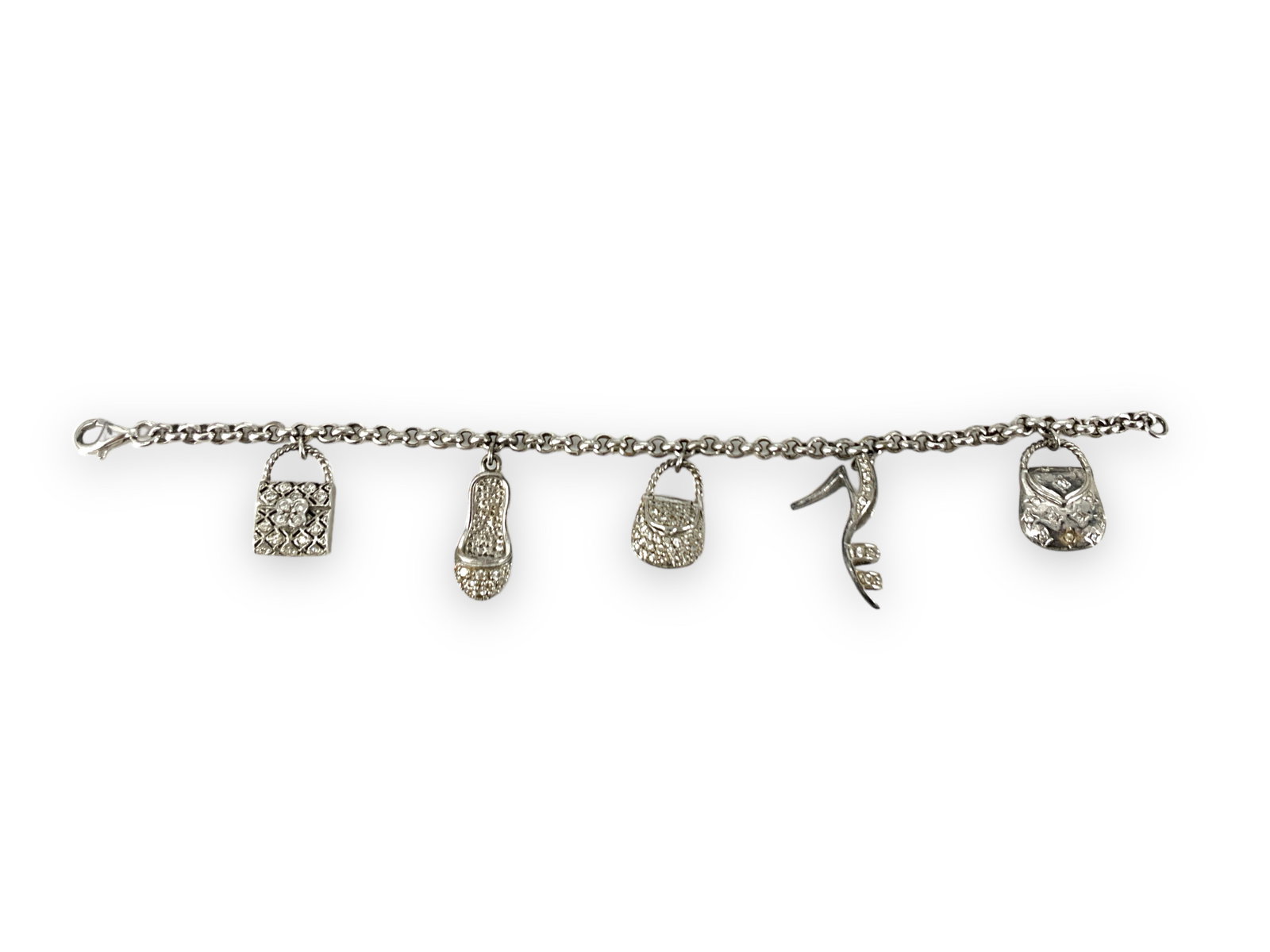 Sterling Silver Charm Bracelet with Charms: Sterling Silver Charm Bracelet with Charms 7.5" in length, 925/sterling silver (stamped and tested), 0.805 troy ounces total weight,with an assortment of fashion charms including purse and shoe design