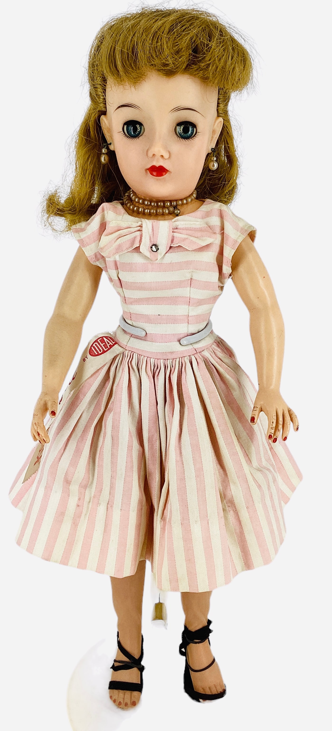 Ideal "Miss Revlon" doll.: Ideal "Miss Revlon" doll. 17 1/2" vinyl doll with rooted hair, sleep eyes with eyelashes, pierced ears, five-piece hard vinyl body. Miss Revlon wears her original tagged dress, undergarments, shoe and