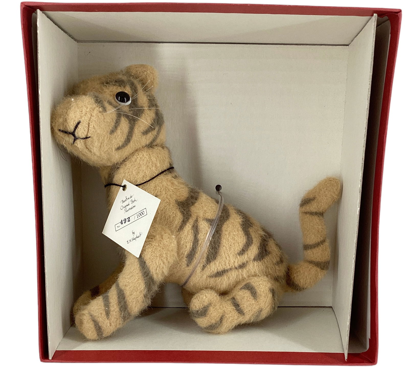 R. John Wright "Tigger".: R. John Wright "Tigger". 7" tall wool felt tiger with applied ears, glass eyes, jointed at the neck, shoulders and hips. Limited Edition No. 492/1000, comes in original box with hang tag.