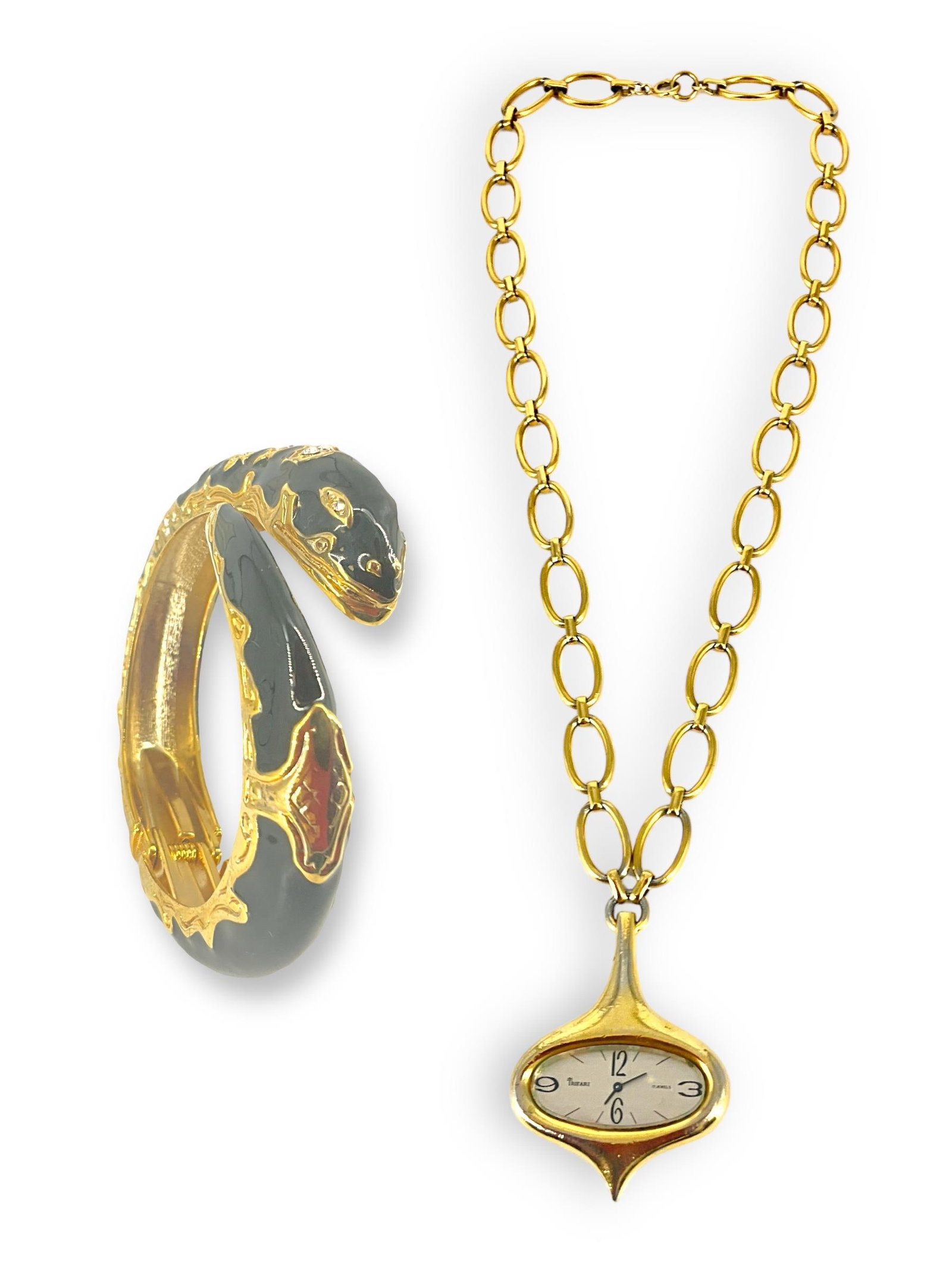 A Pendant Watch by Trifari and a Black Enamel Snake Fashion Bracelet: A Pendant Watch by Trifari and a Black Enamel Snake Fashion Bracelet In the original box is this open-link gold-tone pendant watch by Trifari, watch ticks when wound, not tested for accuracy. Chain is