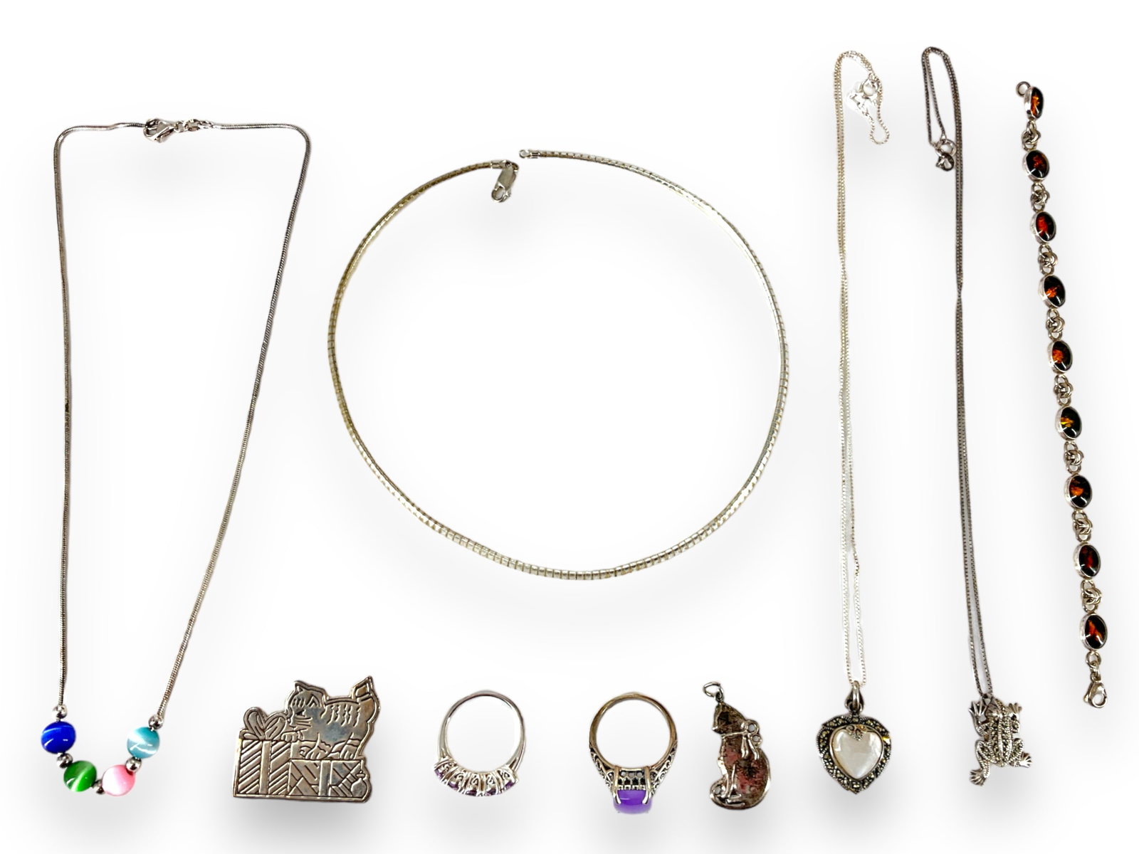 Pretty Silver Pieces: Pretty Silver Pieces All pieces are tested as silver and include the following: 1) A stamped ì925î silver filigree ring, size 9, which has a purple cabochon quartz stone, 2) A silver Omega c