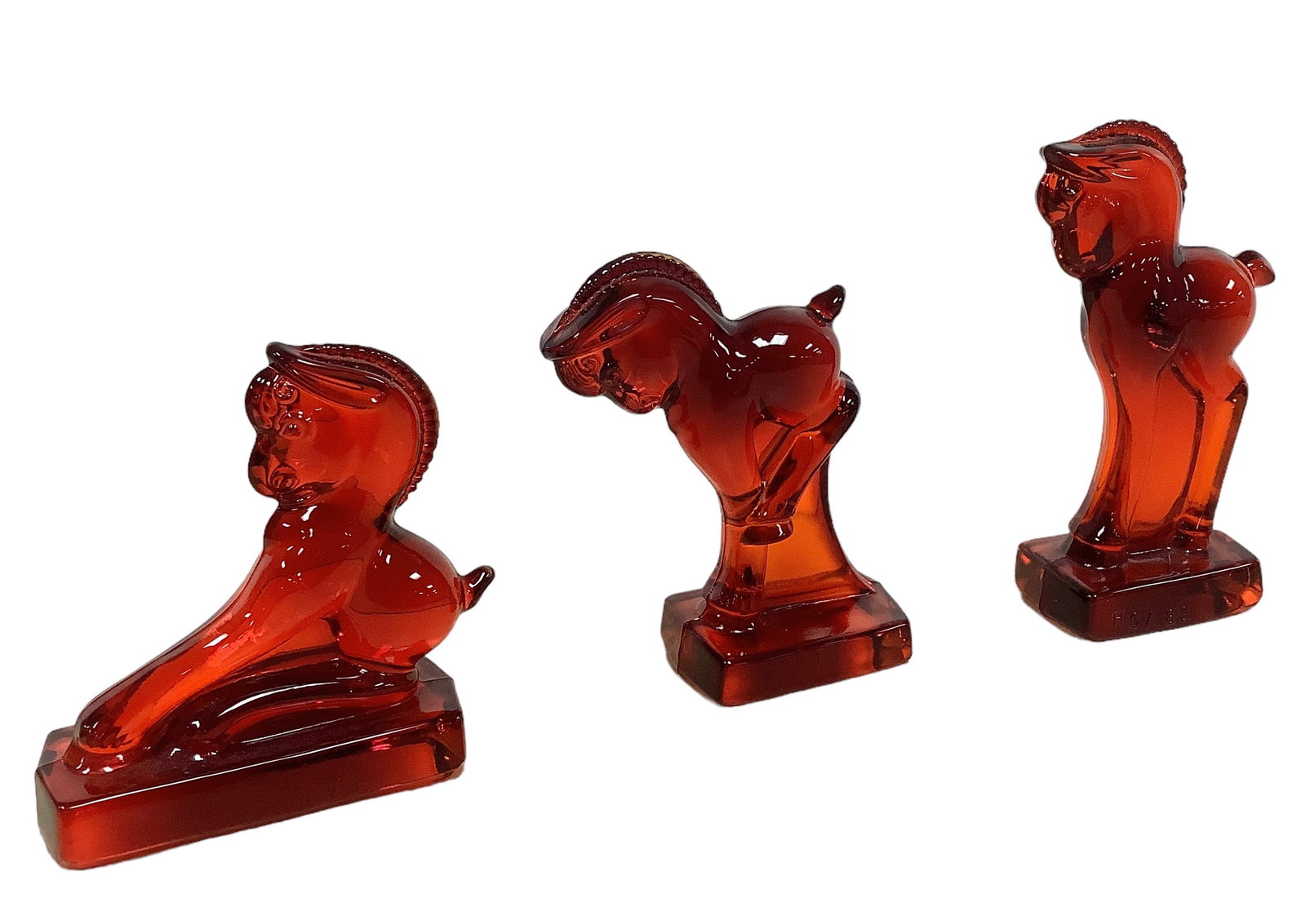 (3) Red Vintage Glass Colts: (3) Red Vintage Glass Colts (1) set of three standing 5"H, balking 3 3/4"H, and kicking 4 1/4" H colts, marked HCA 89, see photo.