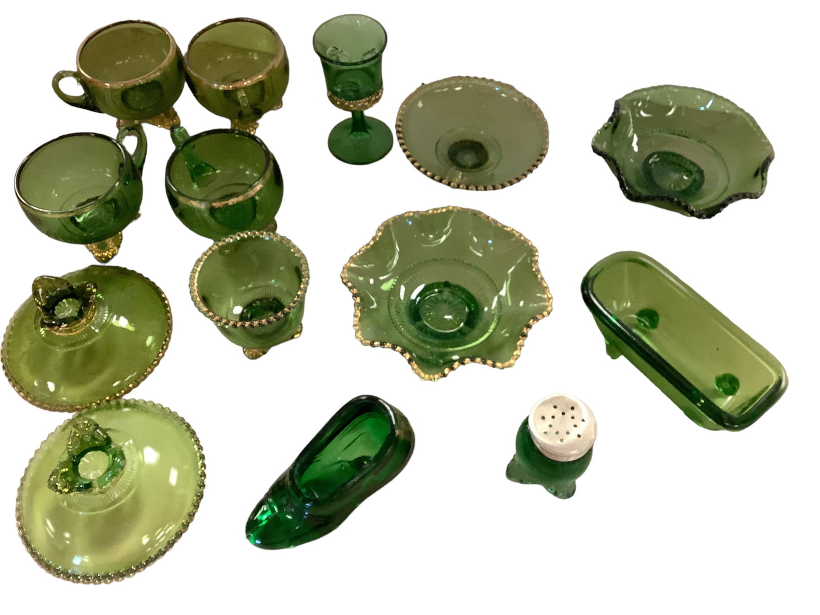 Collection of Various Colorado Emerald Green Glass: Collection of Various Colorado Emerald Green Glass Collection includes glass shoe stamped "souvenir of Monticello". Some chips inside edge; Salt/pepper shaker with damaged lid; bathtub; Footed Berry B