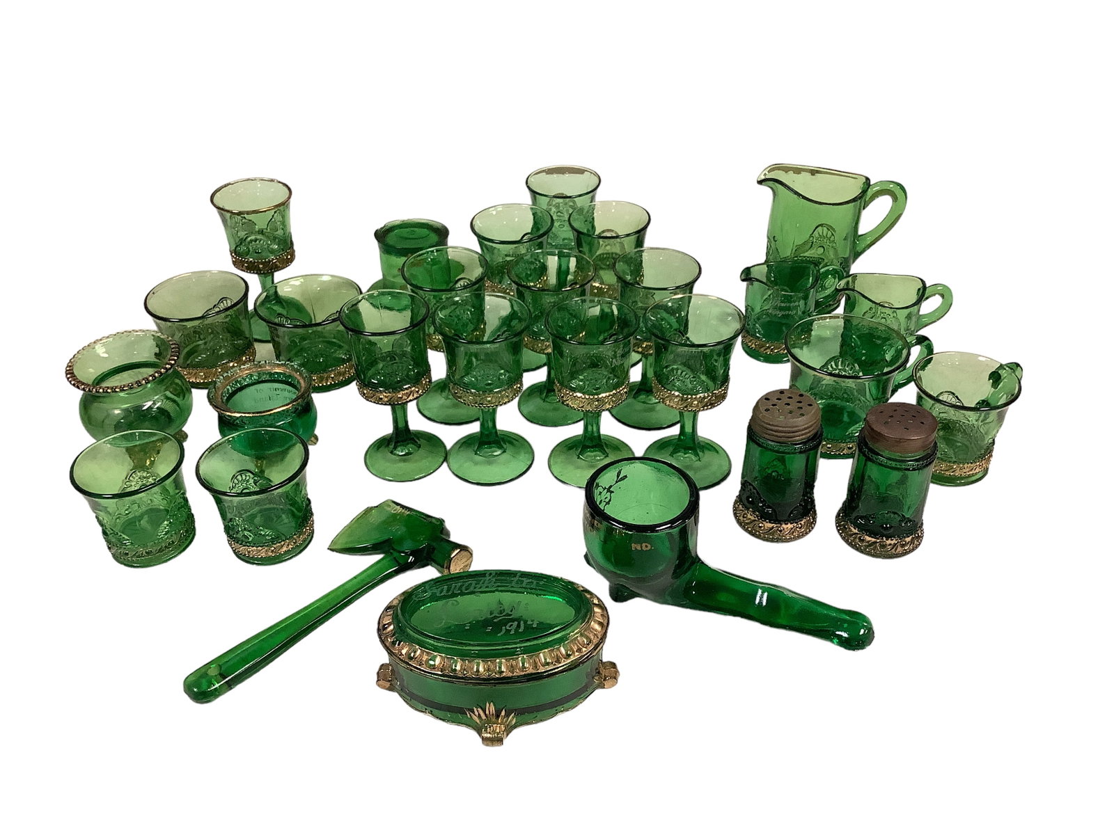 Northwood Gilt Green Souvenir Items: Northwood Gilt Green Souvenir Items Lot of (27) Pieces. Some items dated 1863, 1910, 1914 and 1917. Sizes vary from 2" to 3.75". Items included salt shakers, creamers, small-footed wine glasses, and m