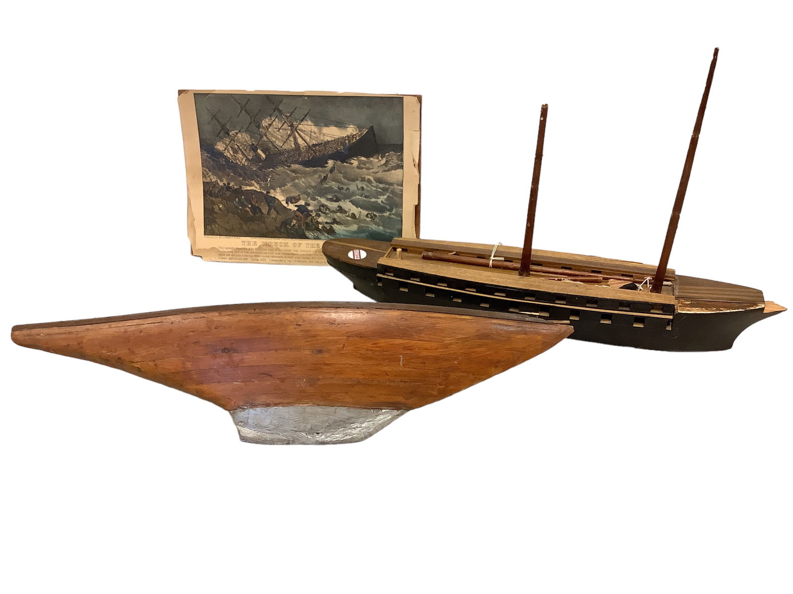 Wooden Ships and Print: Wooden Ships and PrintPrint of "The Wreck of the Atlantic" on broken piece of wood; Folk art large wooden ship with Wooden ship with missing sails, has Ivory tipped mass, approximately 27" long; woode