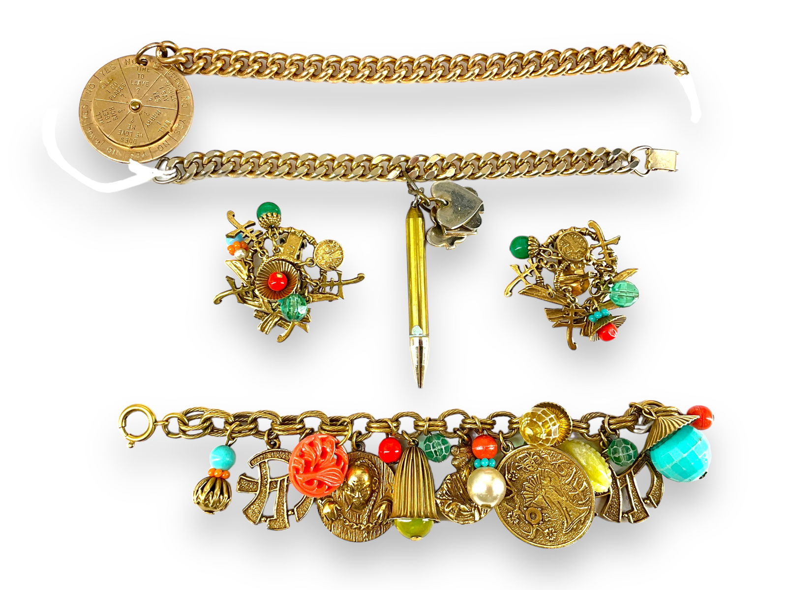 Three Interesting Charm Bracelets in Gold-Tone Metal: Three Interesting Charm Bracelets in Gold-Tone MetalTwo curb link charm bracelets include one at approx 6 1/2" long with a card theme (pencil, heart, spade, etc.) and one @ approx 7" long with a spinn