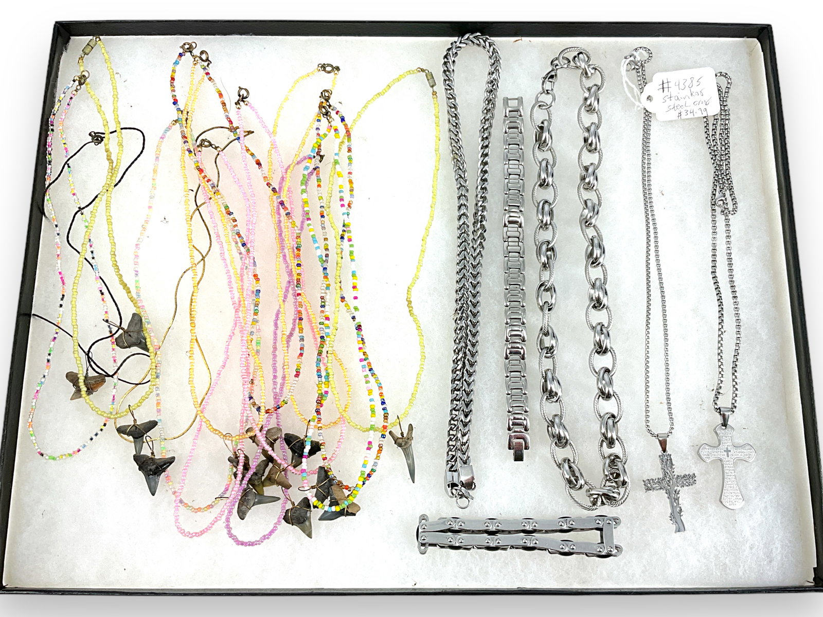 Shark Tooth Necklaces and Stainless Steel Jewelry: Shark Tooth Necklaces and Stainless Steel Jewelry About twelve colorful seed bead necklaces with shark teeth charms/pendants, stainless steel necklaces and bracelets including two chain necklaces with