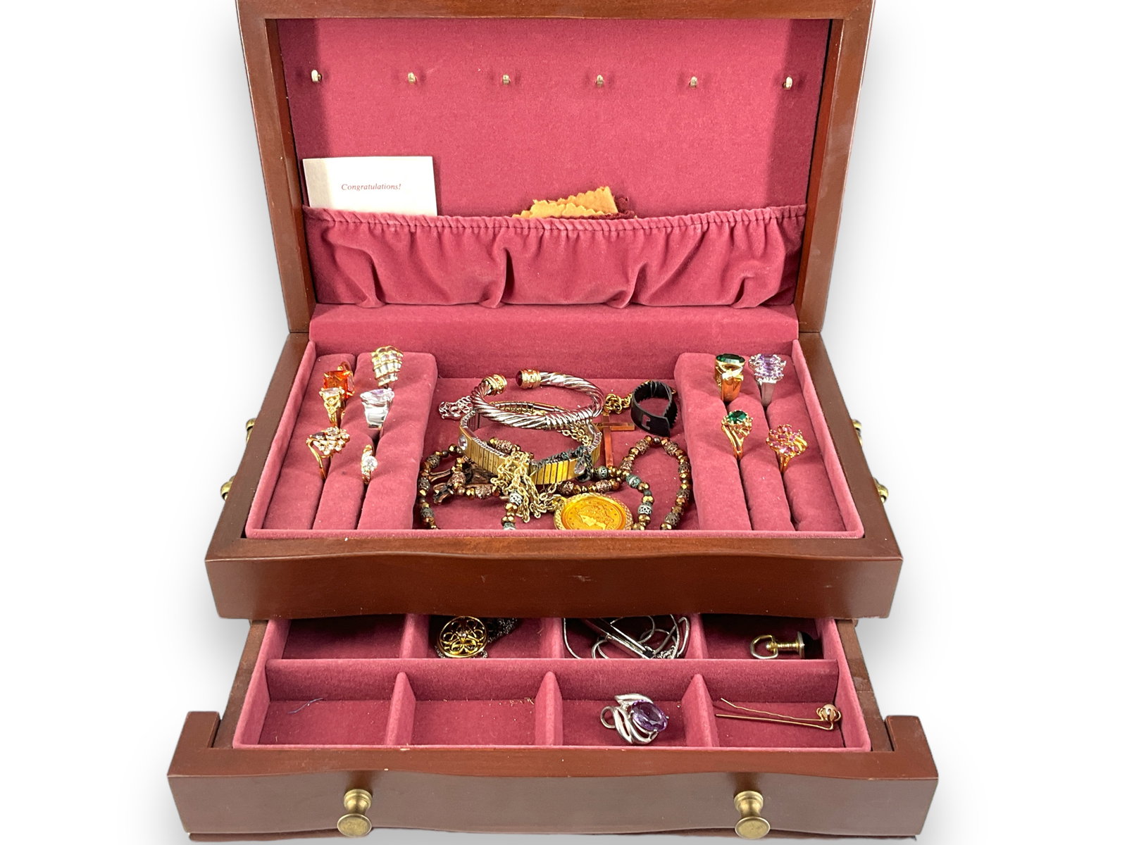 Jewelry Box with Contents: Jewelry Box with Contents Fashion rings, dual tone necklace, hinged bangle, cross pendant on chain, purple crystal slide pendant, pair of cuff links (vintage age) and more. In wooden jewelry box with 
