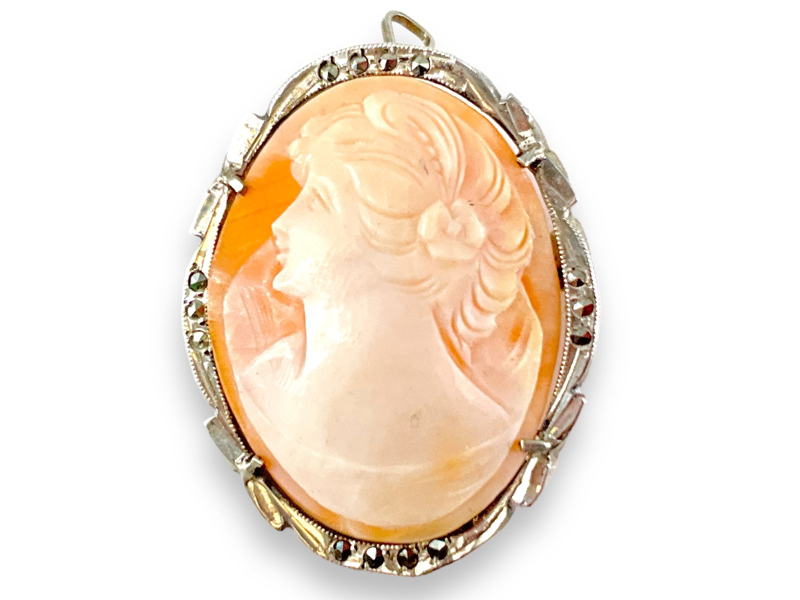 Hand-Carved Shell Cameo in Silver: Hand-Carved Shell Cameo in Silver 800 grade silver mounting, 35.0mm in size, some minor cracks on reverse, with marcasite accents, pin/pendant design.