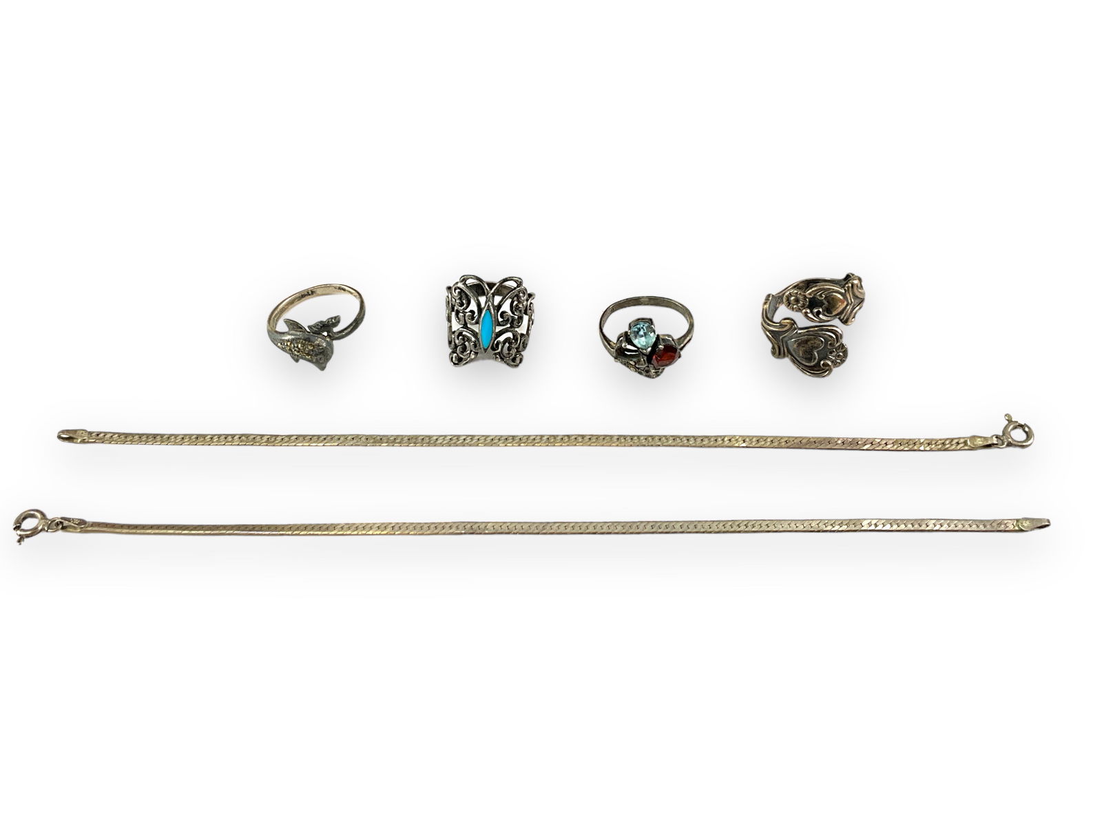 Sterling Silver Accessories: Sterling Silver Accessories0.625 troy ounces total weight, stamped and/or tested 925/sterling silver, four rings and two bracelets, herringbone chain bracelets measuring approximately 7.5" in len