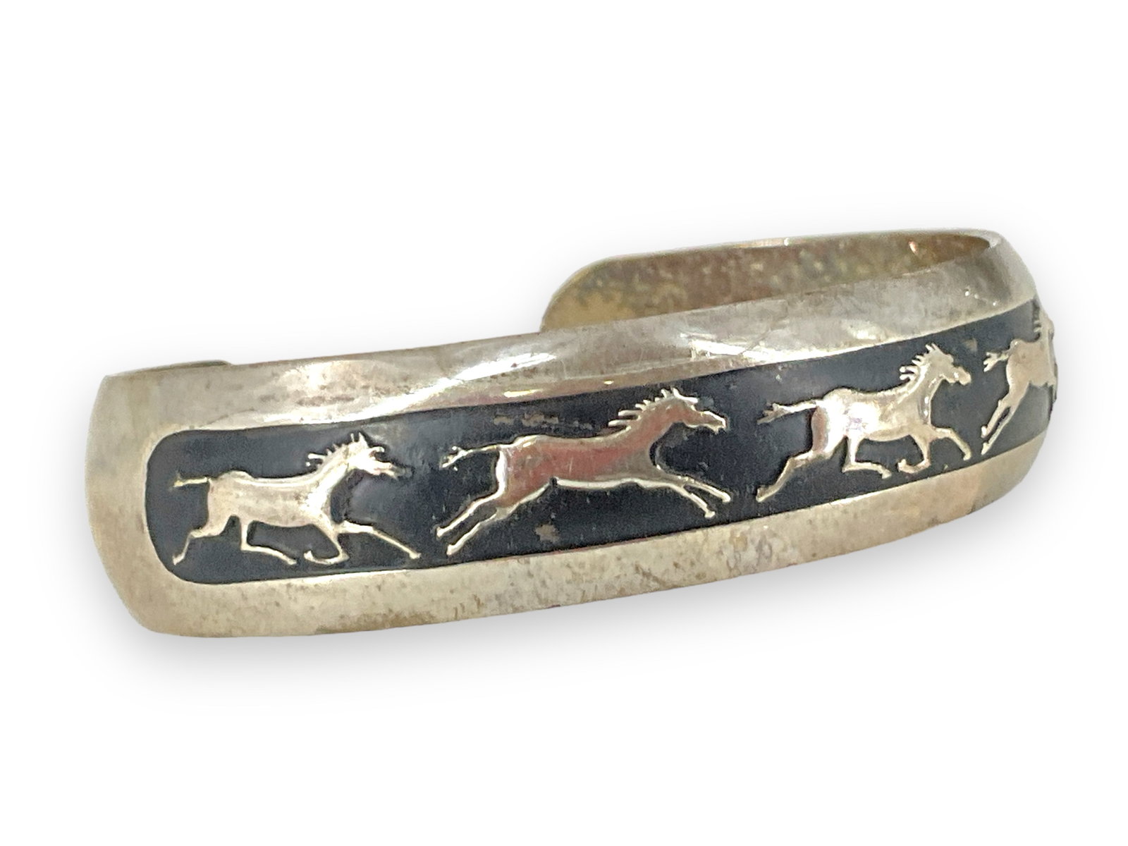 Sterling Silver Bracelet From B. Webb: Sterling Silver Bracelet From B. Webb Open shank measuring (2.3") in diameter and measuring (14.9mm wide) stamped tested and signed with a running horse pattern (0.8 Troy oz tw).