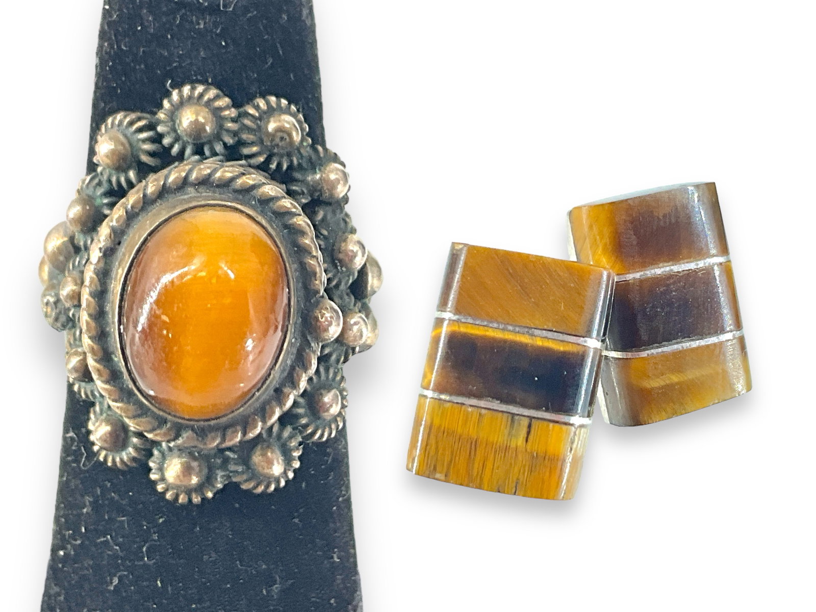 Tiger's Eye Jewelry in Silver: Tiger's Eye Jewelry in Silver Lot has a marked and tested silver ring with an adjustable wrap back, looks to be hand-worked, has abundant detail with a Tiger's Eye cabochon stone center, now is a size