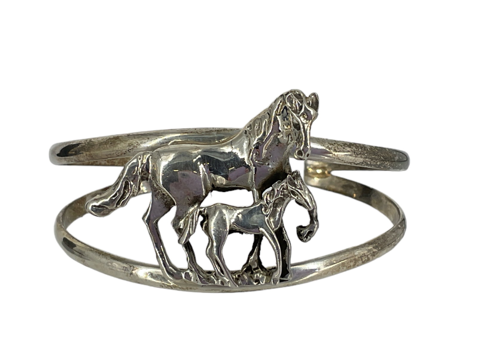 Horse Themed Cuff Bracelet in Silver: Horse Themed Cuff Bracelet in Silver Bracelet is tested silver, has a mother and baby horse featured front and center, has an approx inner circumference of 5.5" and weighs 26.7 grams.