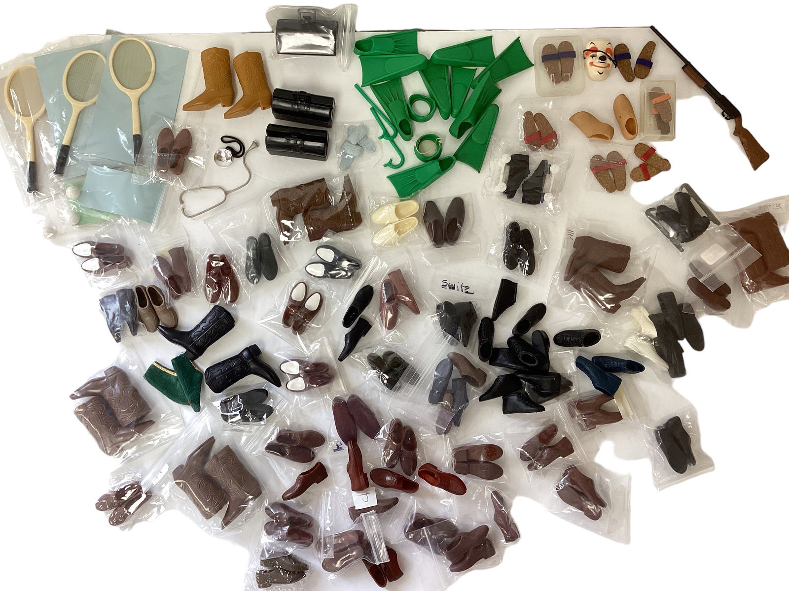 Assortment of Ken Accessories: Assortment of Ken Accessories Mostly shoes & boots, with tennis racquets, gun, swim fins, snorkels & masks, medical bags, & more.