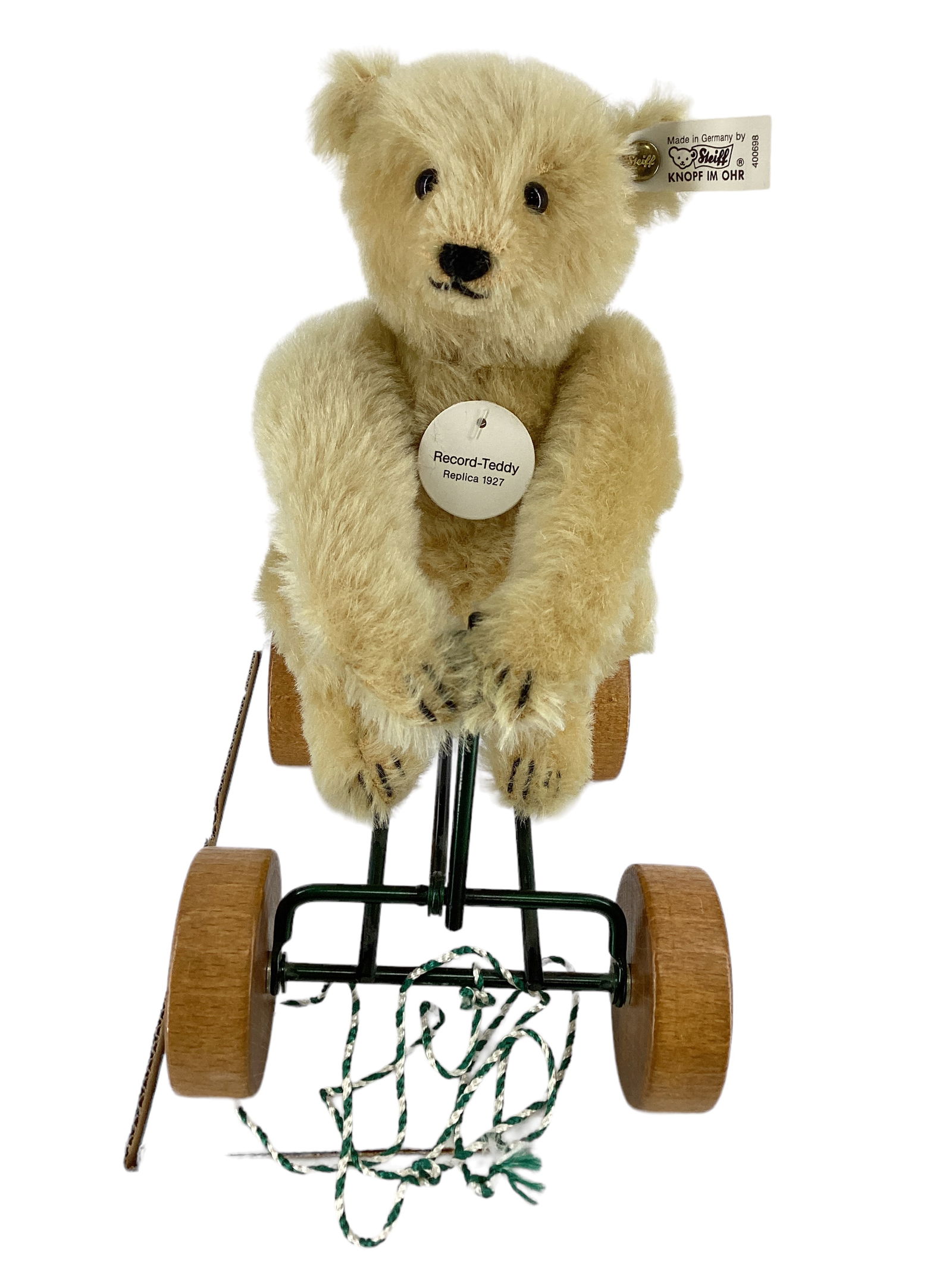 Steiff Replica 1927 "Record-Teddy" on Scooter: Steiff Replica 1927 "Record-Teddy" on Scooter10" tall, mohair, button & tag in ear. #130/ 4000 from 1990. Scooter is 9" long. Wood bellows make a squeak sound as he is pulled, & he makes a rowing moti