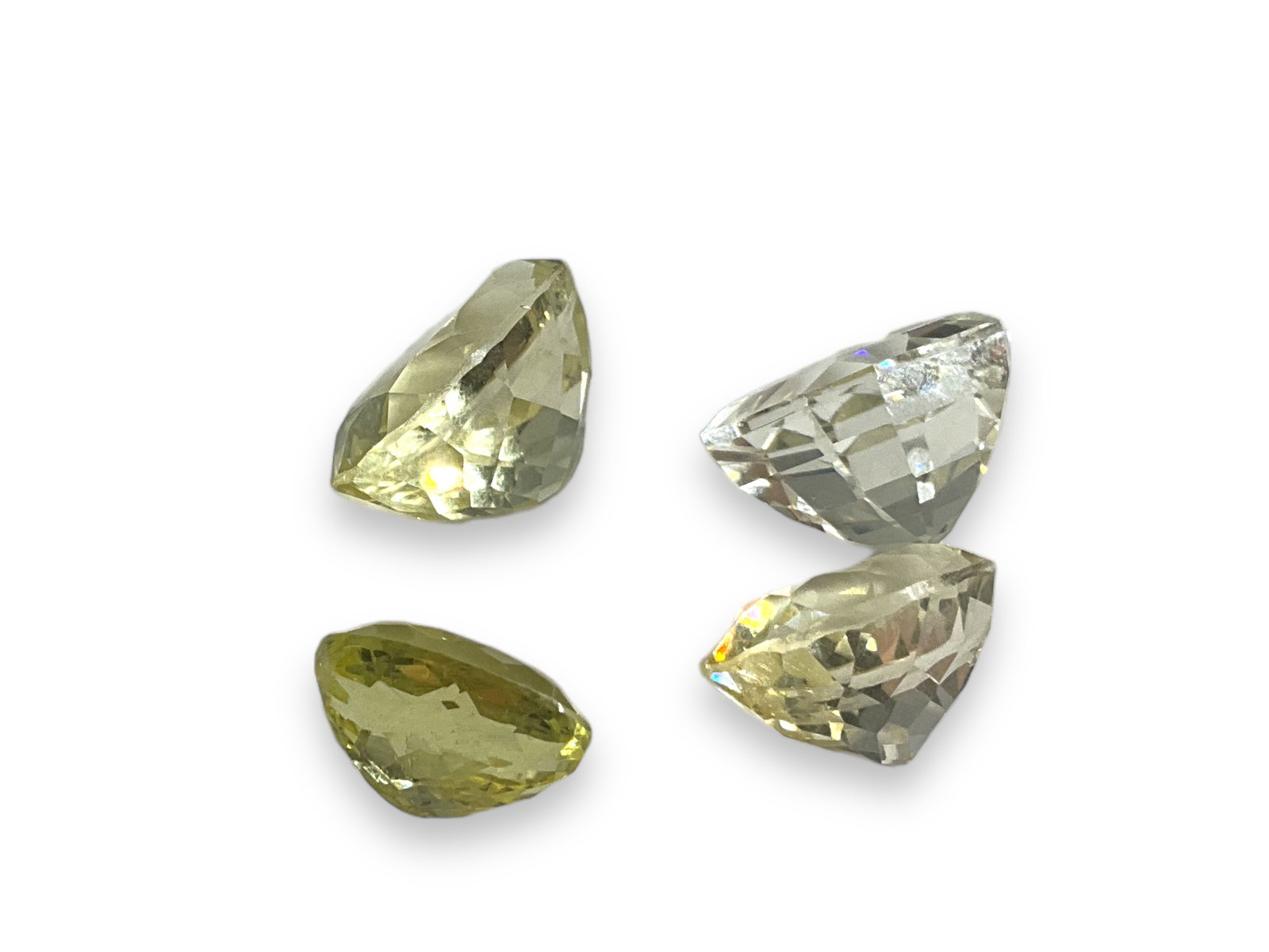 Four Loose Lemon Quartz Semi-Precious Stones: Four Loose Lemon Quartz Semi-Precious Stones Varying degrees of saturation, two with especially pale color, approximately 89.0 cttw, includes three oval cut stones, stones measure up to 23.25mm in siz