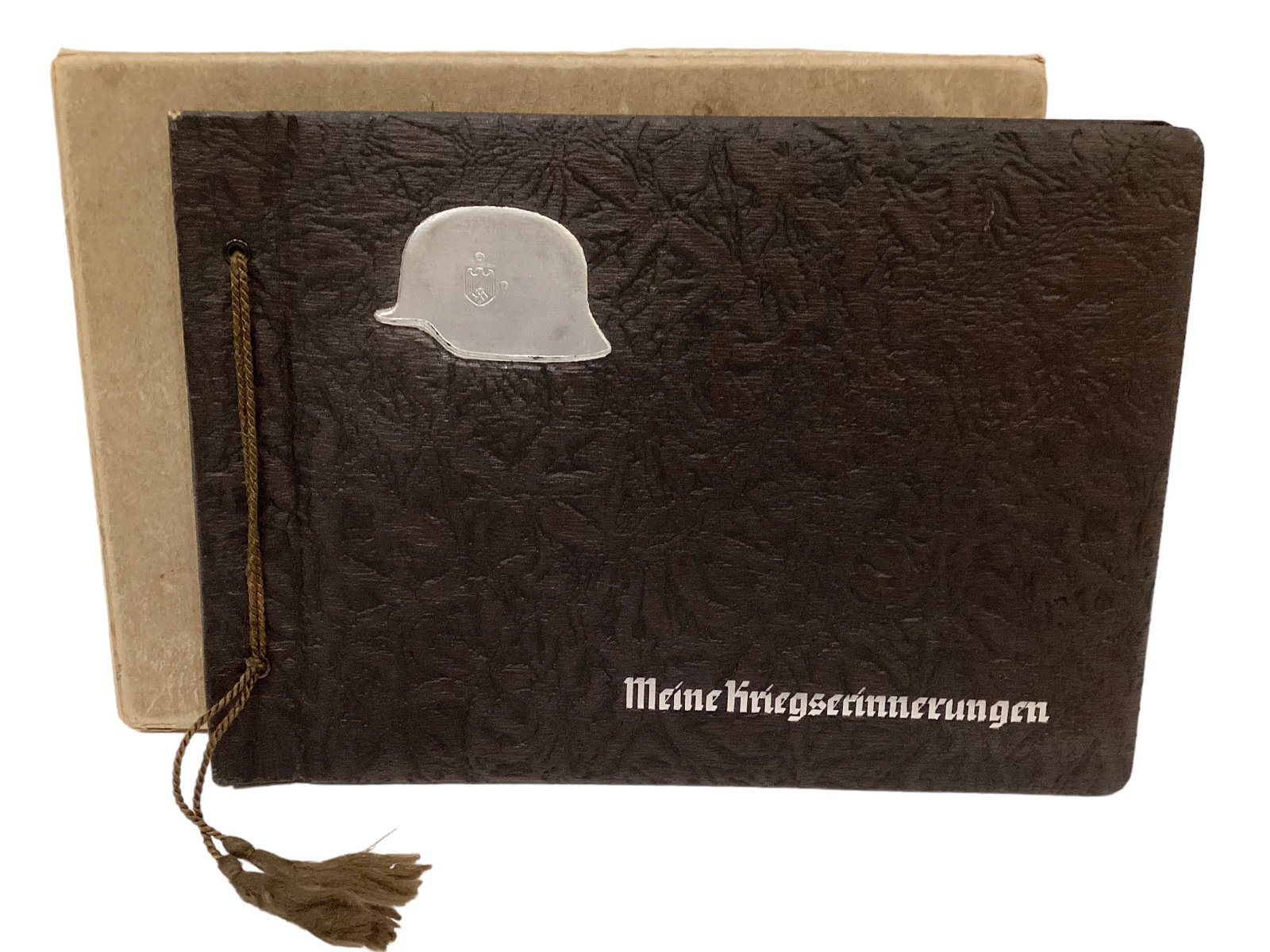 German WWII Army Album with Helmet & Embossed Cover in Original Sleeve: German WWII Army Album with Helmet & Embossed Cover in Original Sleeve The album title translates to My War Memories. It is in as new condition.