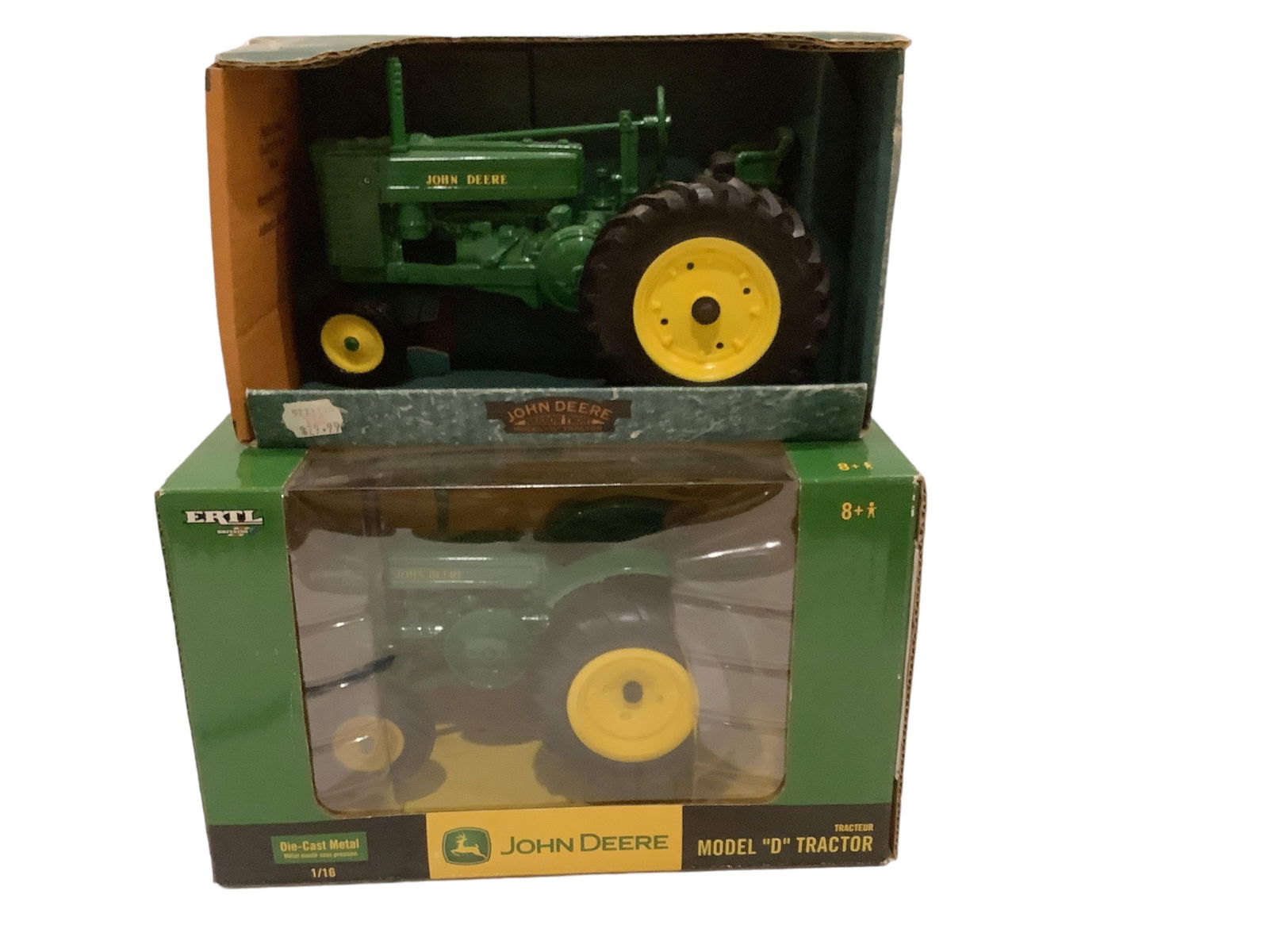 Ertl Diecast Tractors, Lot of (2): Ertl Diecast Tractors, Lot of (2)Includes a John Deere model G and a John Deere model D. Both are 1/16 scale and NIB.