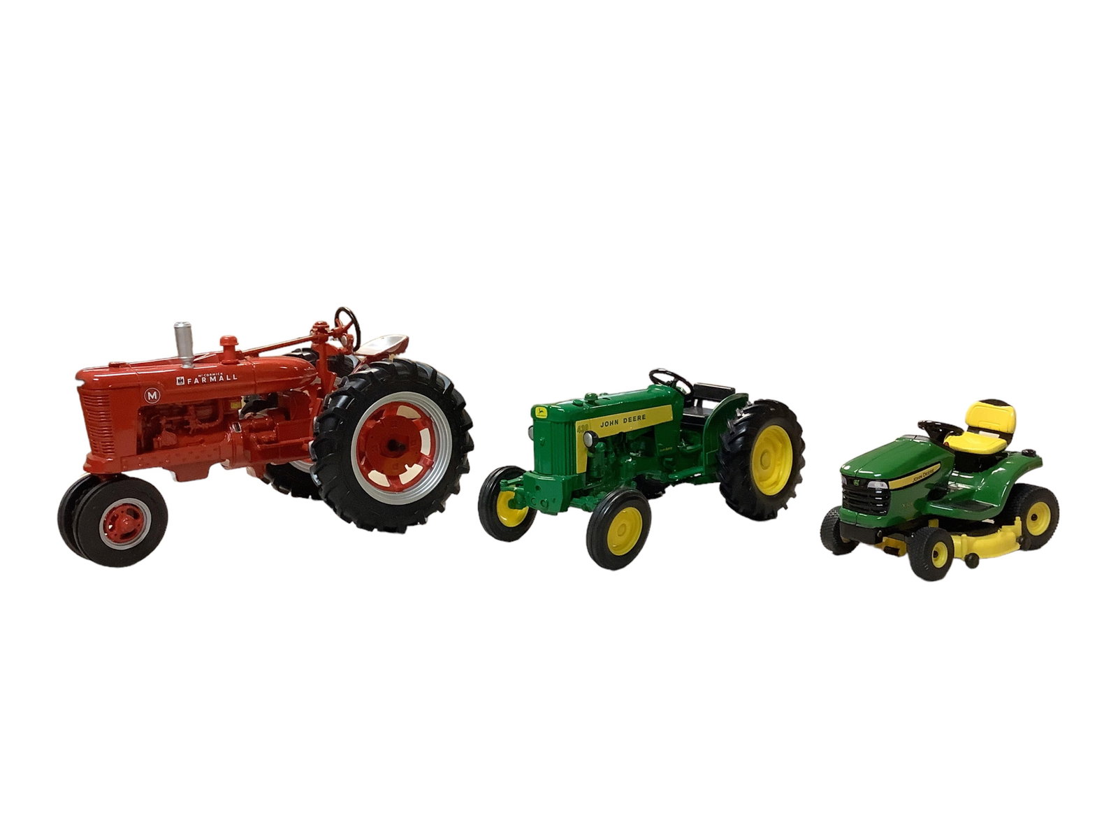 Diecast tractors: Diecast tractors Diecast models: red tractor 8" long, green tractor 7" long and missing exhaust stack, mower 4.5" long