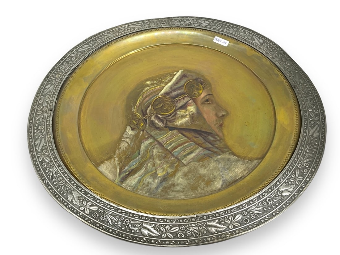 Painted Portrait on Brass Plate in Silver Frame with Floral Decoration: Painted Portrait on Brass Plate in Silver Frame with Floral Decoration16.25" in diameter, silver tone metal rim/frame with a floral design (natural motif), painted with Rudolph Valentino portrait