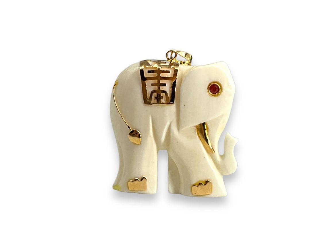 Pleasing Elephant Pendant in Ivory. **See Selling Information**: Pleasing Elephant Pendant in Ivory. **See Selling Information** Sweet elephant pendant is approx 1" tall and has 14k yellow gold embellishments and has a faceted ruby eye. Pendant weighs 2.76 grams. *