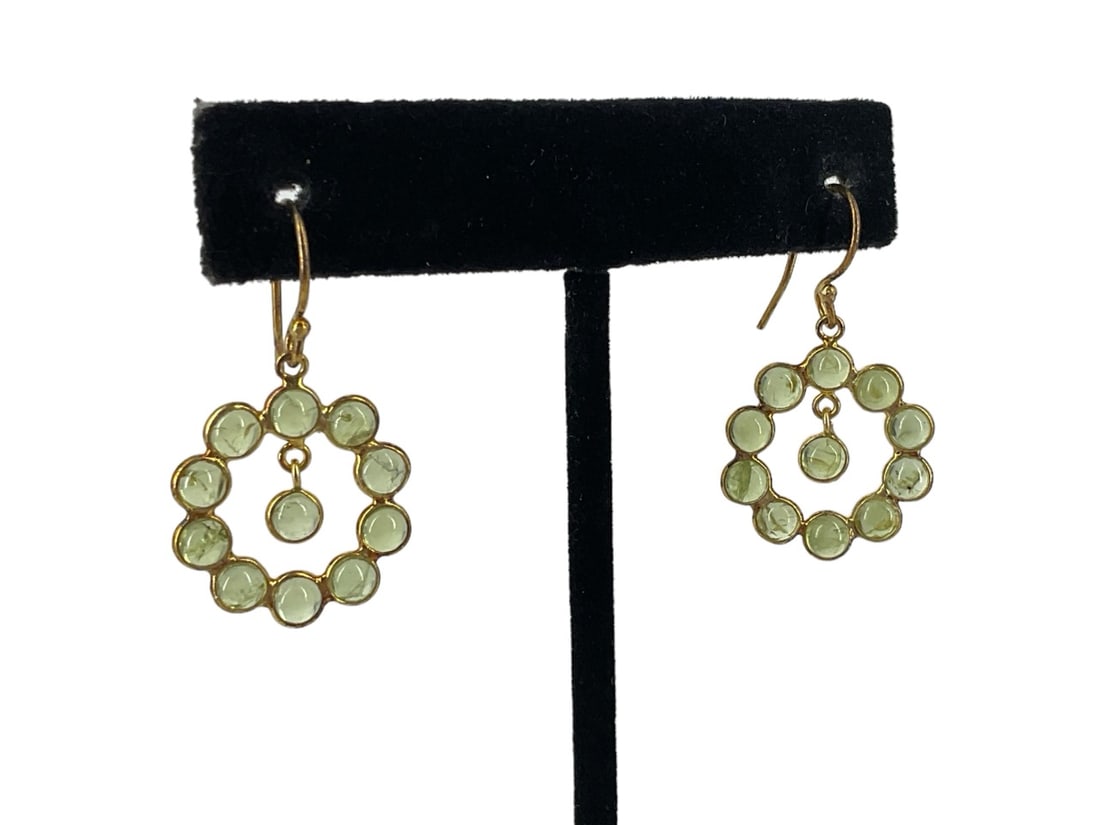 Delightful Vermeil Peridot Earrings: Delightful Vermeil Peridot Earrings Measuring (1.3") in length with bezel set peridot cabochons in a halo accented with a peridot dangle in the center, each stone measures approx. (3.4mm) in diameter 