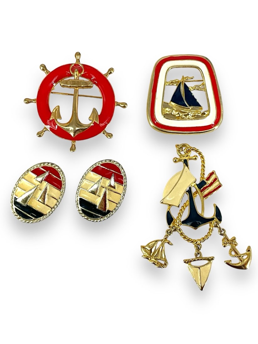 Vintage Nautical Accessories: Vintage Nautical Accessories Gold tone pendant measuring approx. (3" x 1.4") with red white and blue enameling, (2.17") ships wheel pin with red enameling, (1.79" x 1.65") openwork pun with a sailboat