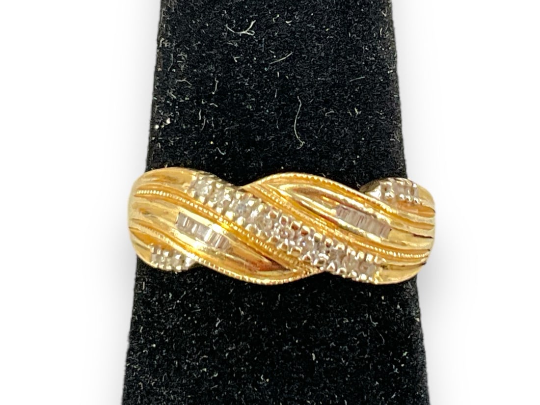 14kt Yellow Gold Diamond Swirl Band: 14kt Yellow Gold Diamond Swirl BandPerfect for anyone who loves to stack rings or for wearing solo. Size(7) tapered shank with five rows of round / baguette cut meleediamonds that accent each swirl of