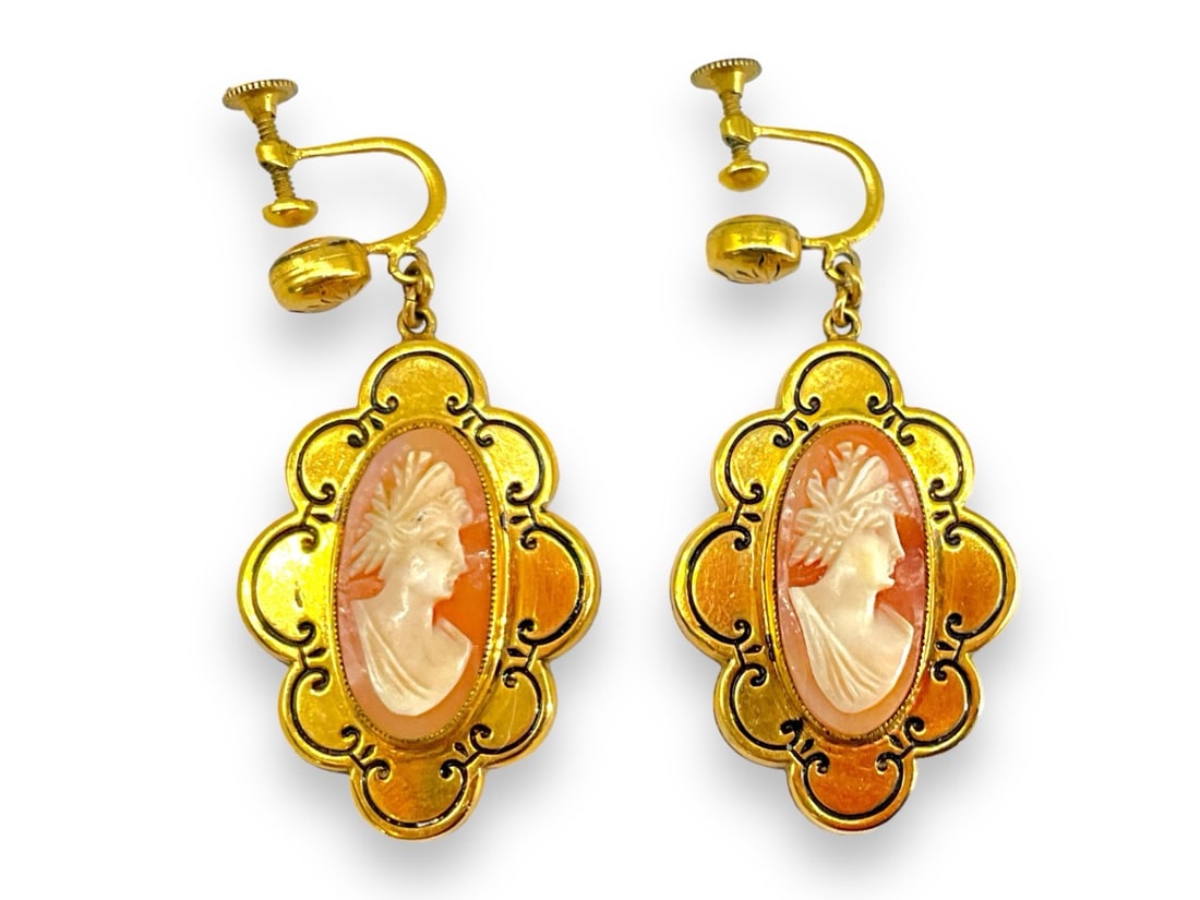 Vintage Gold-Filled Cameo Earrings: Vintage Gold-Filled Cameo Earrings Vintage earrings test gold-filled and feature shell cameos of a woman in profile with black trace enameling as an accent. Earrings are approx 1 3/4" tall and have sc