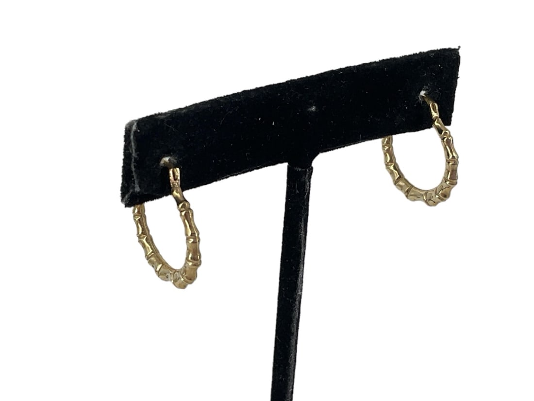 10kt Yellow Gold Hoop Earrings: 10kt Yellow Gold Hoop Earrings Measuring (0.75") in length, graduated bamboo motif with hinged post backs, stamped and tested (0.5 grams tw).