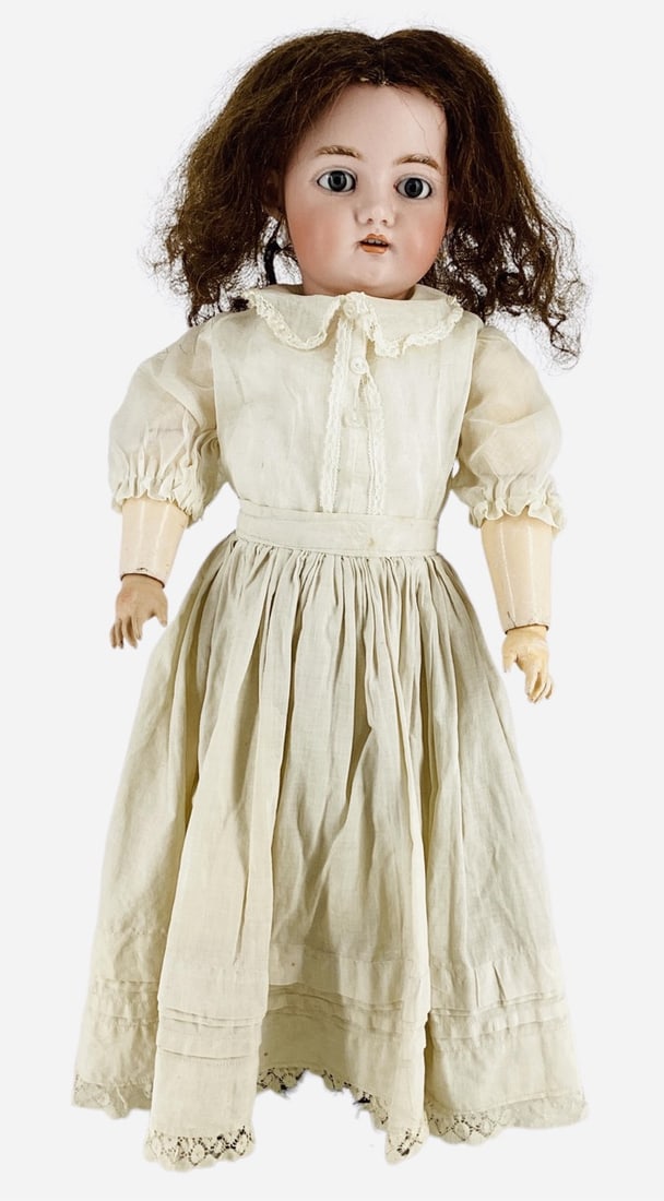 Franz Schmidt & Co. bisque socket head girl.: Franz Schmidt & Co. bisque socket head girl.Marked "S&C", 22" doll with human hair wig, glass sleep eyes, molded brows, pierced ears, open mouth with teeth, on jointed composition body.