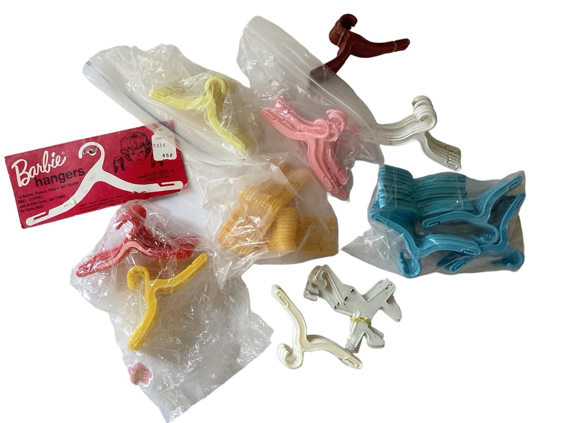 Bag of Vintage Barbie Hangers w / Top of Original Bag Only: Bag of Vintage Barbie Hangers w / Top of Original Bag Only (1) Large lot of vintage hangers in different colors along with the original cardboard part of top only of original bag that includes picture