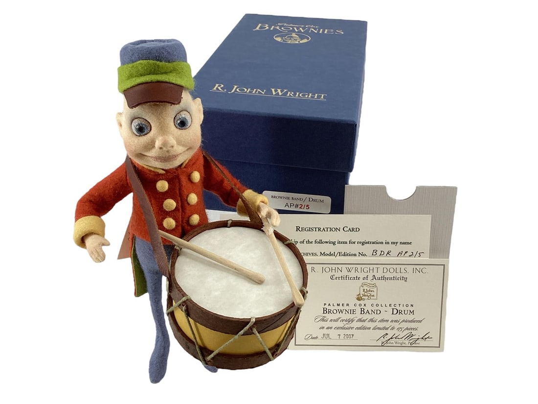 "Brownie Band ~ Drum" Doll by R. John Wright Artist Proof #2/5.: "Brownie Band ~ Drum" Doll by R. John Wright Artist Proof #2/5.All felt; molded hand painted features; height 8"; jointed arms and neck; wired legs; leather hat brim. Holding carved wooden drumst