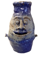 Pottery Planter with Face Approximately 14" tall. Opening is 3.5"