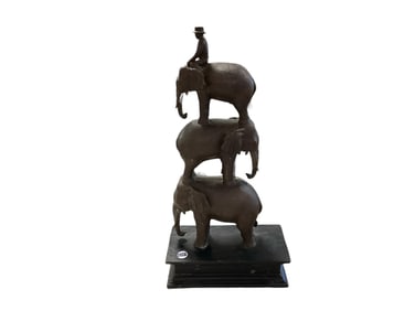 Sculpture of a Man Riding Three Elephants