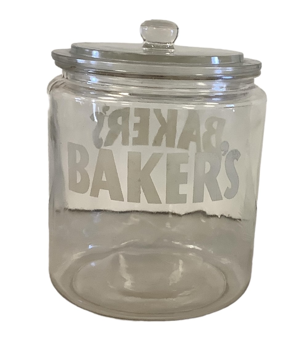Baker's Cookie Jar: Baker's Cookie JarBaker's cookie/cracker jar, two ladies on either side, two Baker's Logo on each side. Comes with original lid, chip in glass directly below lid. Approx 9" tall.