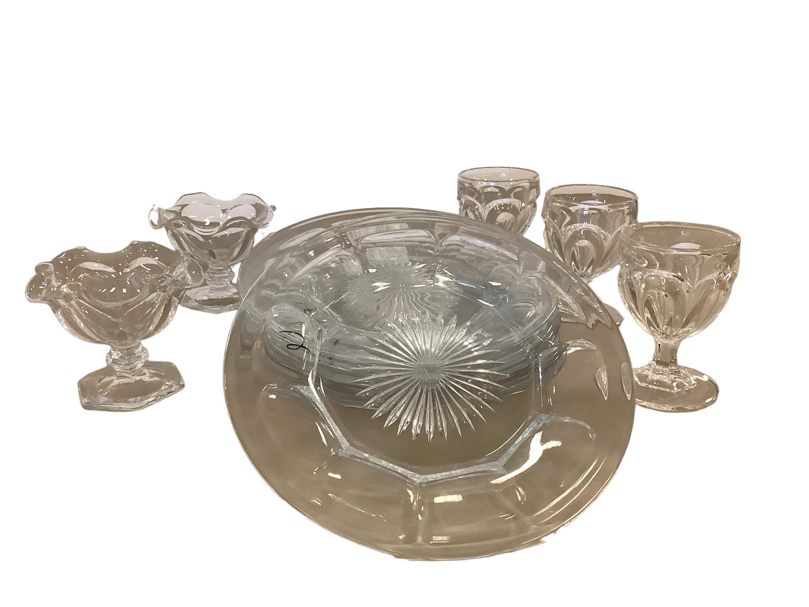 Box Lot of (11) Miscellaneous Glass Items to Include Heisey and Early Egg Cups: Box Lot of (11) Miscellaneous Glass Items to Include Heisey and Early Egg Cups(3) Early Colonial Type Egg Cups makers unknown.(6) 8" #1150 Plates H.(2) Puritan Sherbet Crimped Top H.