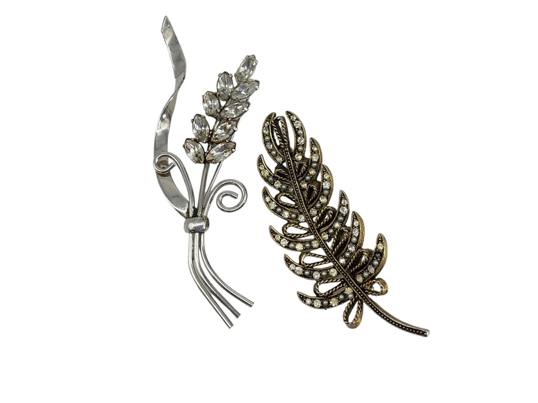 Vintage Brooches by Coro and HAR: Vintage Brooches by Coro and HARVintage silver-tone brooch is designed as a single flower bouquet, is signed on the reverse "Coro" and is approx 4" tall. Brooch has diamantÈ crystal accents in the fl