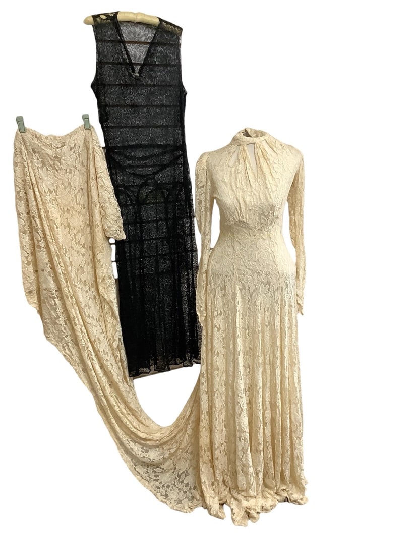 Ivory Lace Wedding Dress and Black Lace Gown: Ivory Lace Wedding Dress and Black Lace GownDress is all lace with a long train and measures 22" at waist and 30"at bust. Dress buttons up the back with 35 buttons and has buttoned sleeve cuffs. Gown