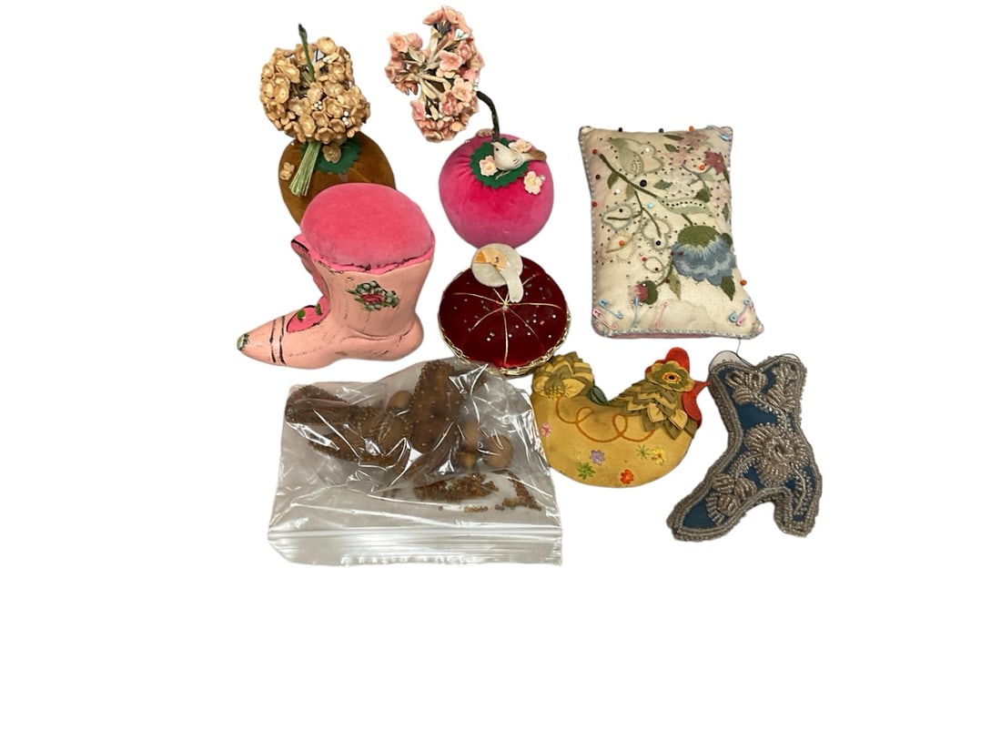 Variety of vintage pin cushions: Variety of vintage pin cushions (8) ranging from 4" T to 6" T.