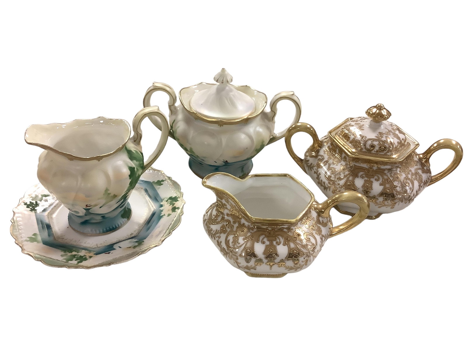 (2) Cream and Sugar Sets: (2) Cream and Sugar Sets Two beautiful cream and sugar sets. Both have maker's marks. One is labeled Prussia. Stunning detail.