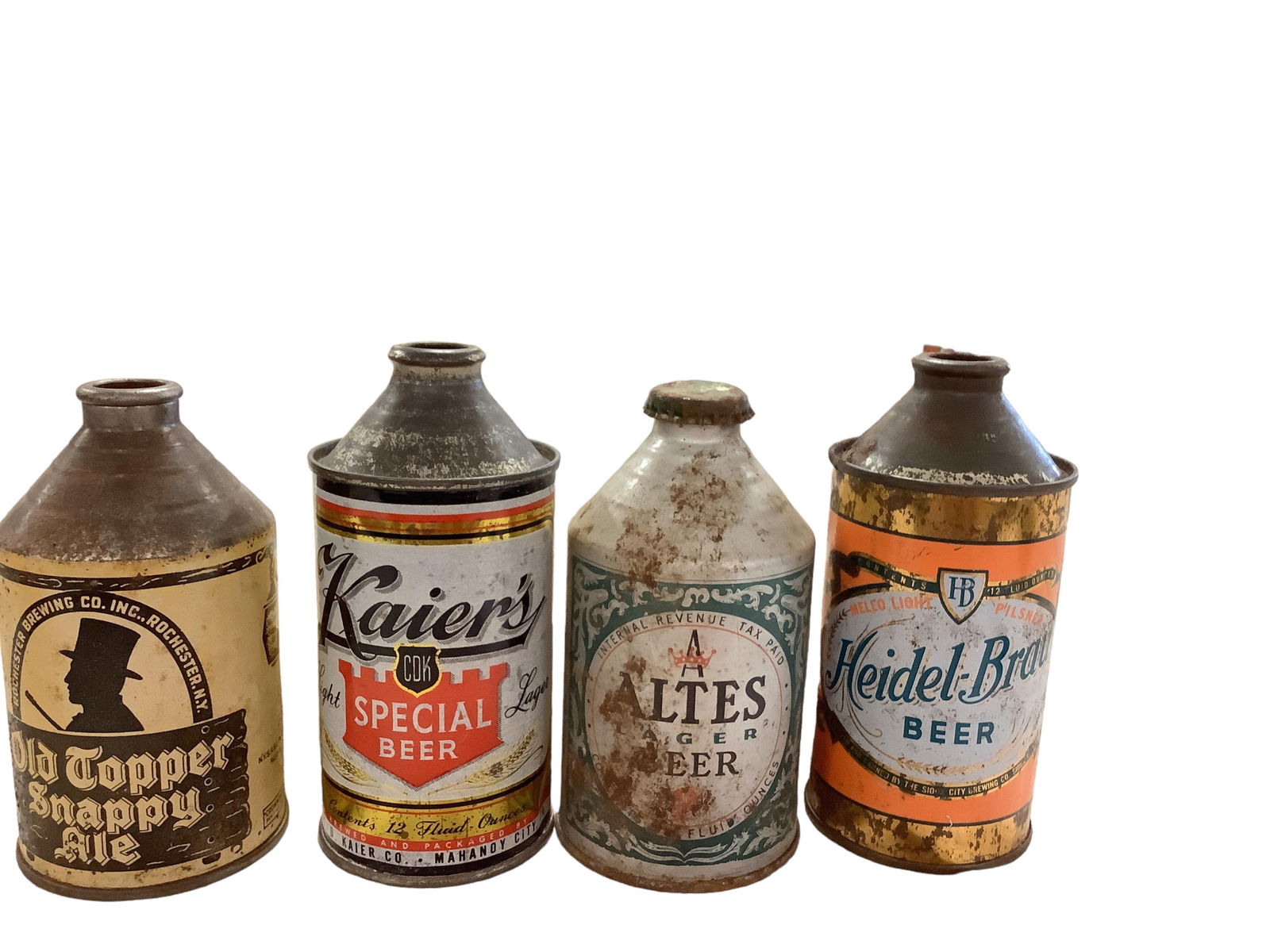 (4) Vintage Tin Beer Cans: (4) Vintage Tin Beer Cans(1) Old Topper Snappy Ale, (1) Kaiser's Light, (1) Altes Lager with cap returned, (1) Heidelberg-Brau BeerSizes range from 5.5" to 6"